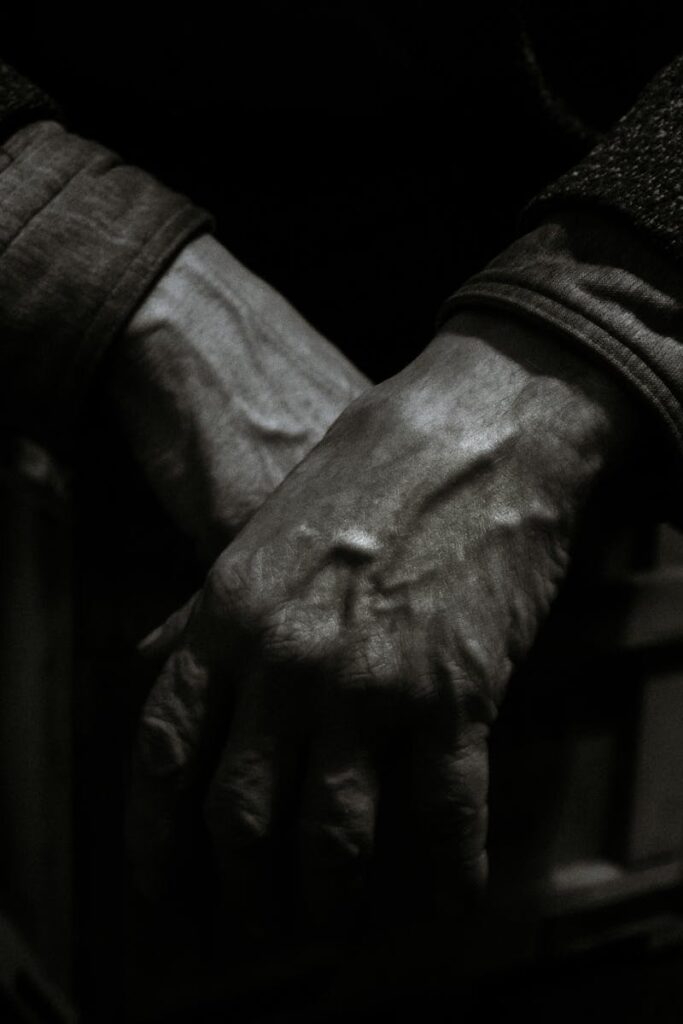 pexels-photo-5637349-5637349-1 Dramatic black and white close-up photo showcasing aged hands folded together, expressing emotion and texture.